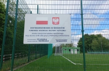 tablica z napisami zawieszona na siatce